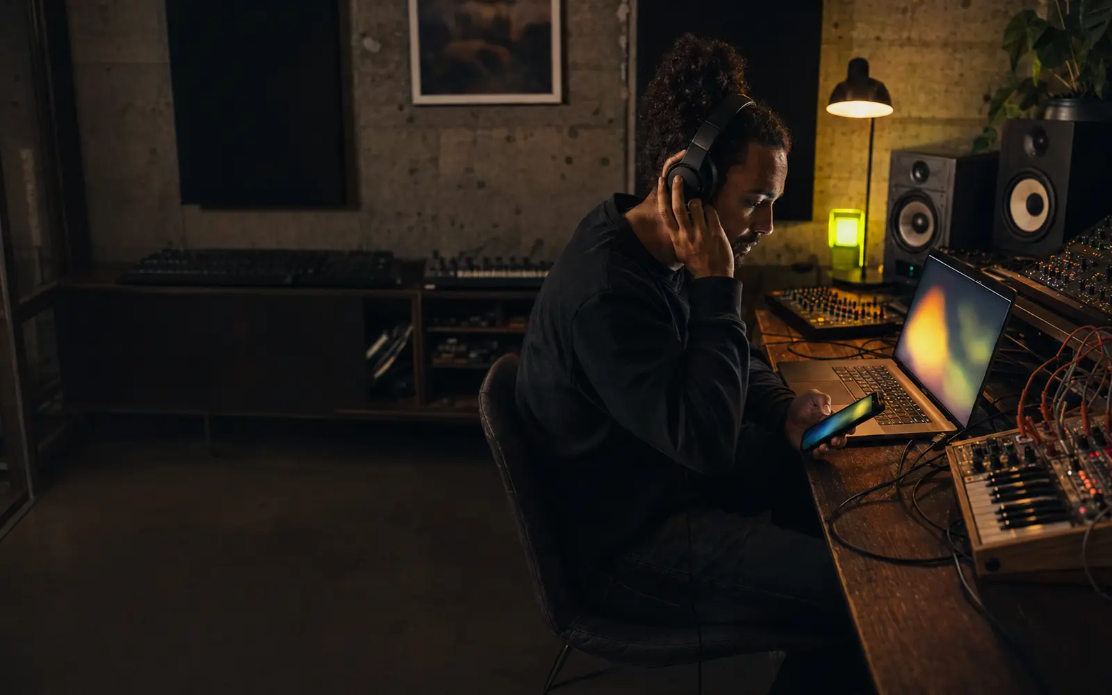Electronic artist reviewing community activity in a real studio