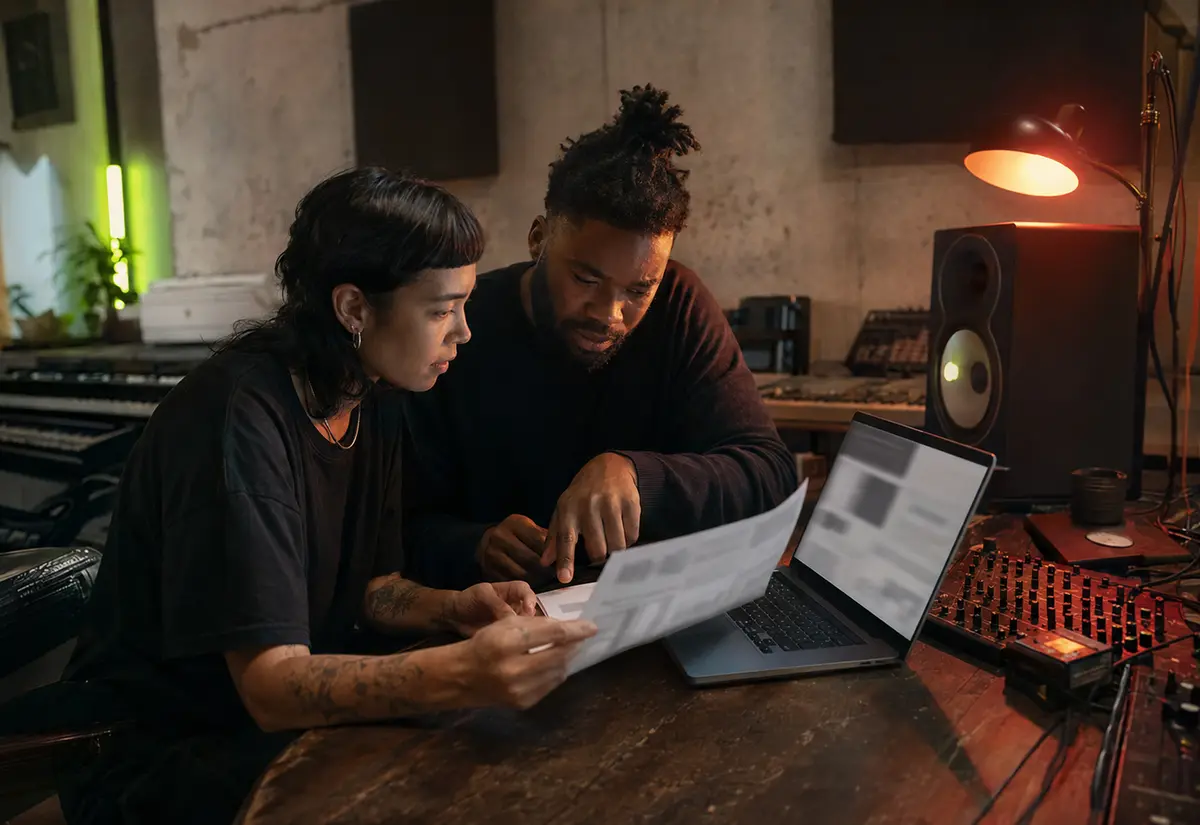 Artist and collaborator reviewing suspicious campaign data